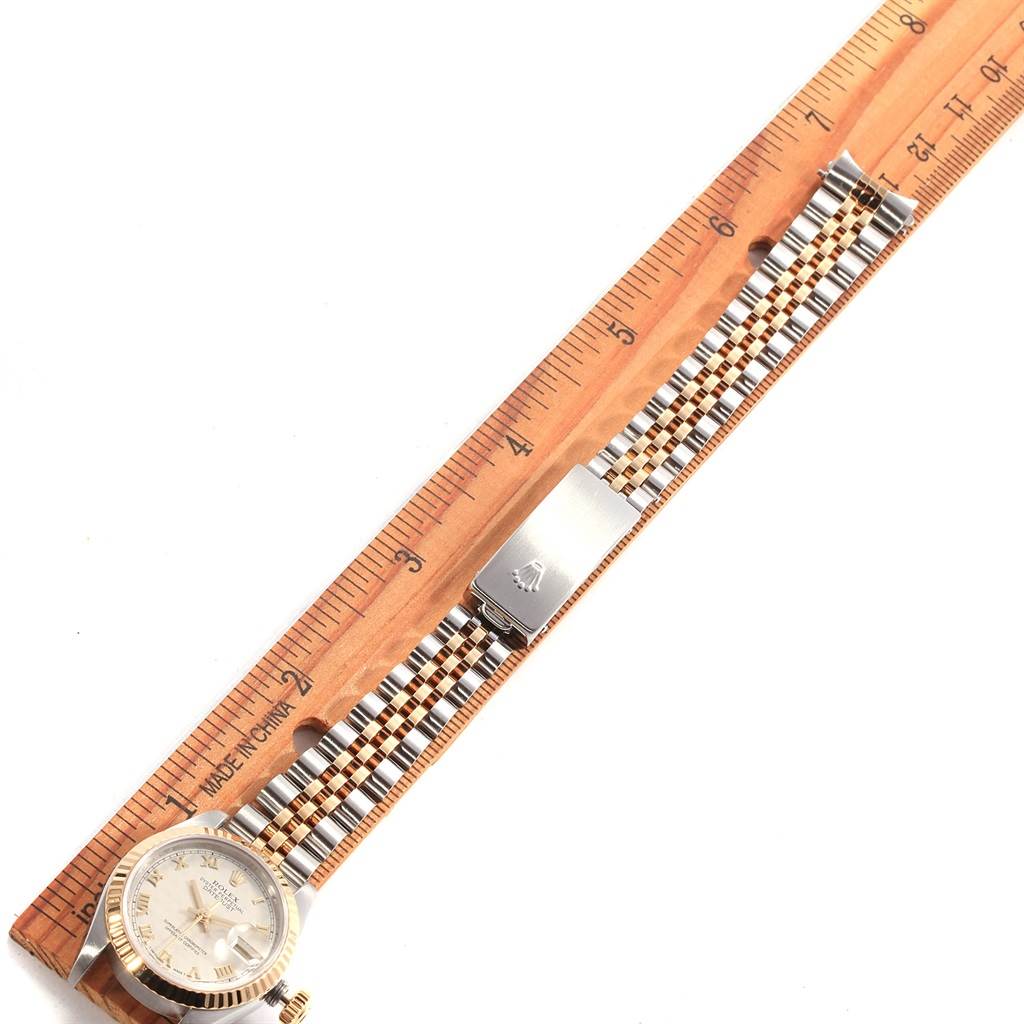 The image shows a Rolex Datejust 69173 Women's Stainless Steel Beige Dial 69173 Women's Stainless Steel Beige Dial watch laid flat next to a ruler, displaying its face and steel and gold bracelet.