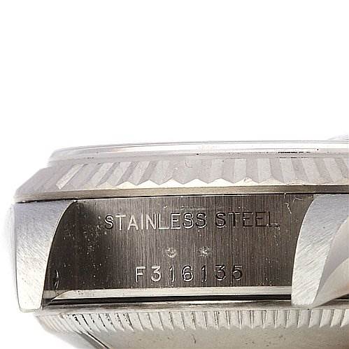 This image shows a close-up side view of the stainless steel case of a Rolex Datejust 79174 Women's Stainless Steel Blue Dial 79174 Women's Stainless Steel Blue Dial watch, highlighting the serial number engraving.