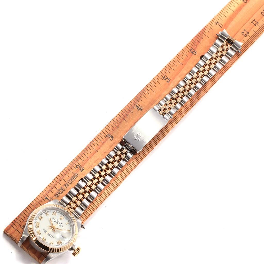 The image shows a Rolex Datejust 69173 Women's Stainless Steel White Dial 69173 Women's Stainless Steel White Dial watch laid flat on a ruler, highlighting the face and the full length of the bracelet.