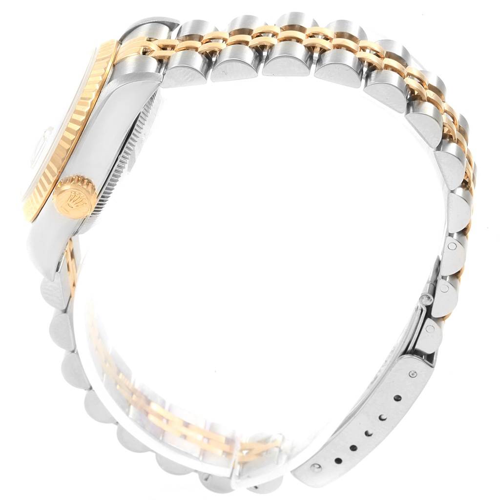 The image shows a side view of the Rolex Datejust 69173 Women's Stainless Steel White Dial 69173 Women's Stainless Steel White Dial watch focusing on the crown, case edge, and the two-tone bracelet.