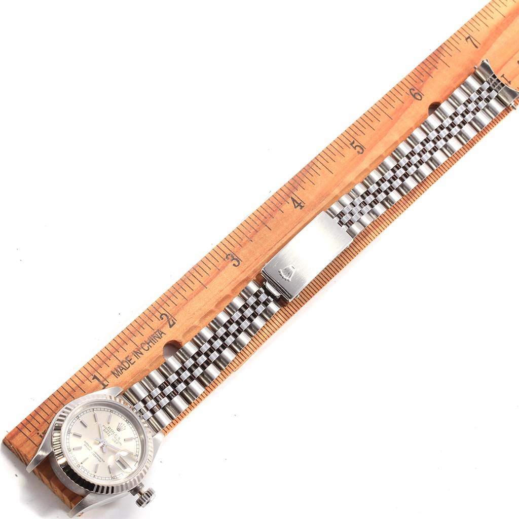 This image shows a Rolex Datejust 69174 Women's Stainless Steel Silver Dial 69174 Women's Stainless Steel Silver Dial watch laid flat next to a ruler, displaying the dial, bracelet, and clasp.