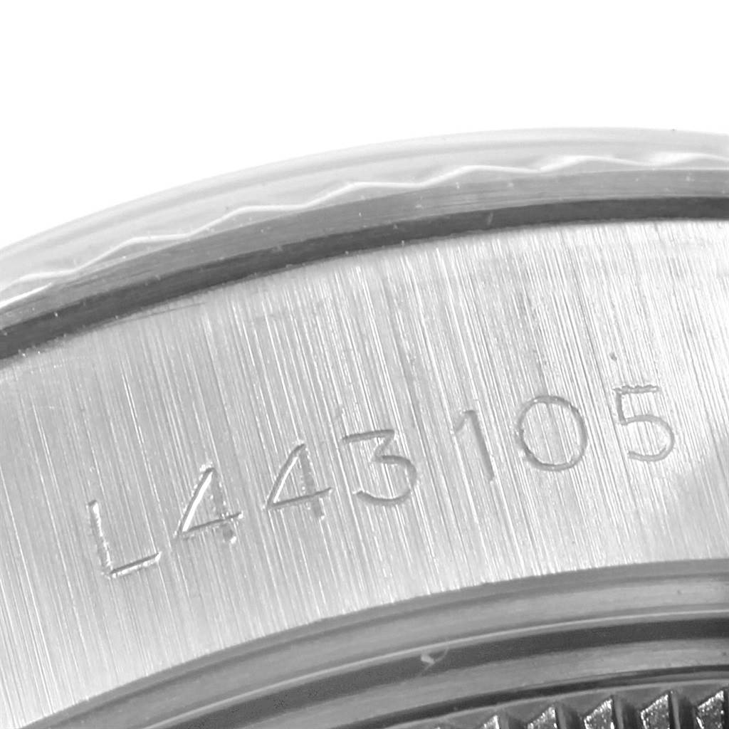 This is a close-up image showing the serial number engraving on the case of a Rolex Datejust 69174 Women's Stainless Steel Silver Dial 69174 Women's Stainless Steel Silver Dial watch.