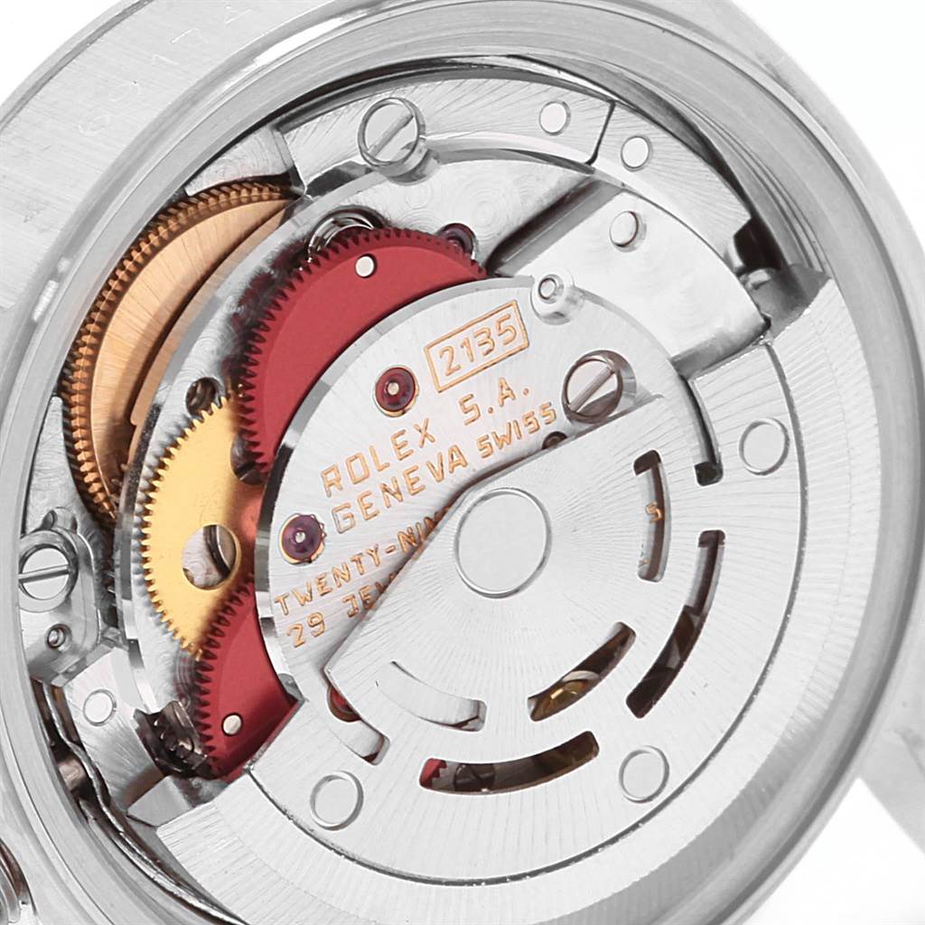 The image shows a close-up view of the Rolex Datejust 69174 Women's Stainless Steel Silver Dial 69174 Women's Stainless Steel Silver Dial watch's inner mechanism with visible gears and inscriptions.