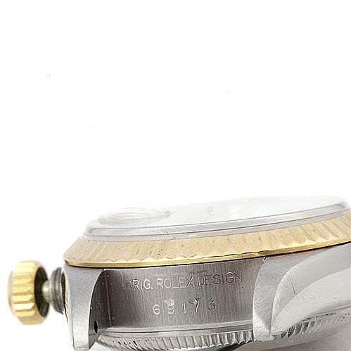 This close-up angle shows the side view of a Rolex Datejust 69173 Women's Stainless Steel Silver Dial 69173 Women's Stainless Steel Silver Dial, highlighting the crown, bezel, and part of the casing with engravings.