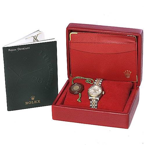 A Rolex Datejust 69173 Women's Stainless Steel Silver Dial 69173 Women's Stainless Steel Silver Dial watch is shown in an open red box with its green manual and tags.