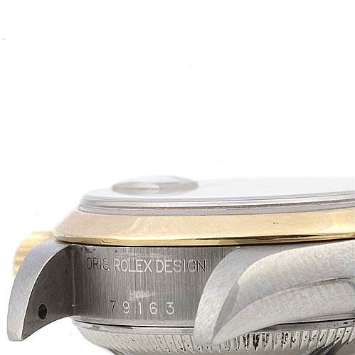 This image shows a close-up side view of the case, crown, and lug of a Rolex Datejust 79163 Women's Yellow Gold Champagne Dial 79163 Women's Yellow Gold Champagne Dial with the model number engraved.