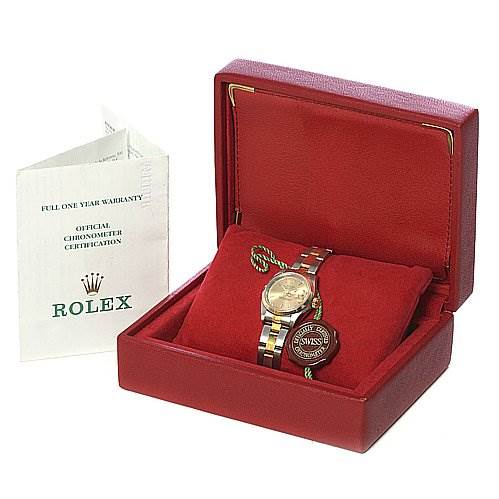 The Rolex Datejust 79163 Women's Yellow Gold Champagne Dial 79163 Women's Yellow Gold Champagne Dial watch is displayed in an open red box, accompanied by a certification booklet on the side.