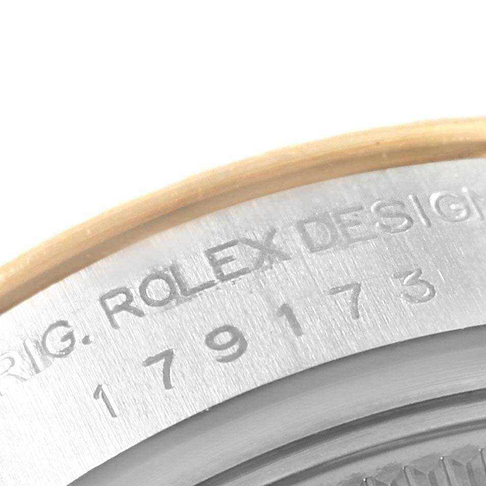 The image shows a close-up of the serial number and engraving on the side of the case back of a Rolex Datejust 179173 Women's Steel and Gold (two tone) Mother of Pearl Dial 179173 Women's Steel and Gold (two tone) Mother of Pearl Dial watch.