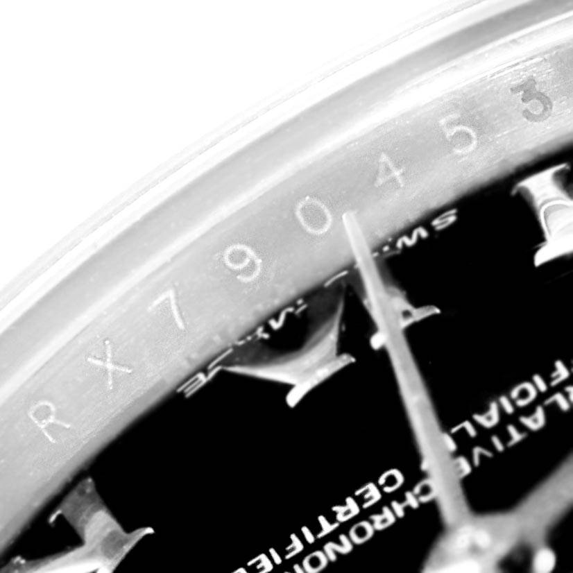 The image shows a close-up of the bezel and part of the dial of a Rolex Datejust 179160 Women's Stainless Steel Black Dial 179160 Women's Stainless Steel Black Dial watch, including the serial number engraving.