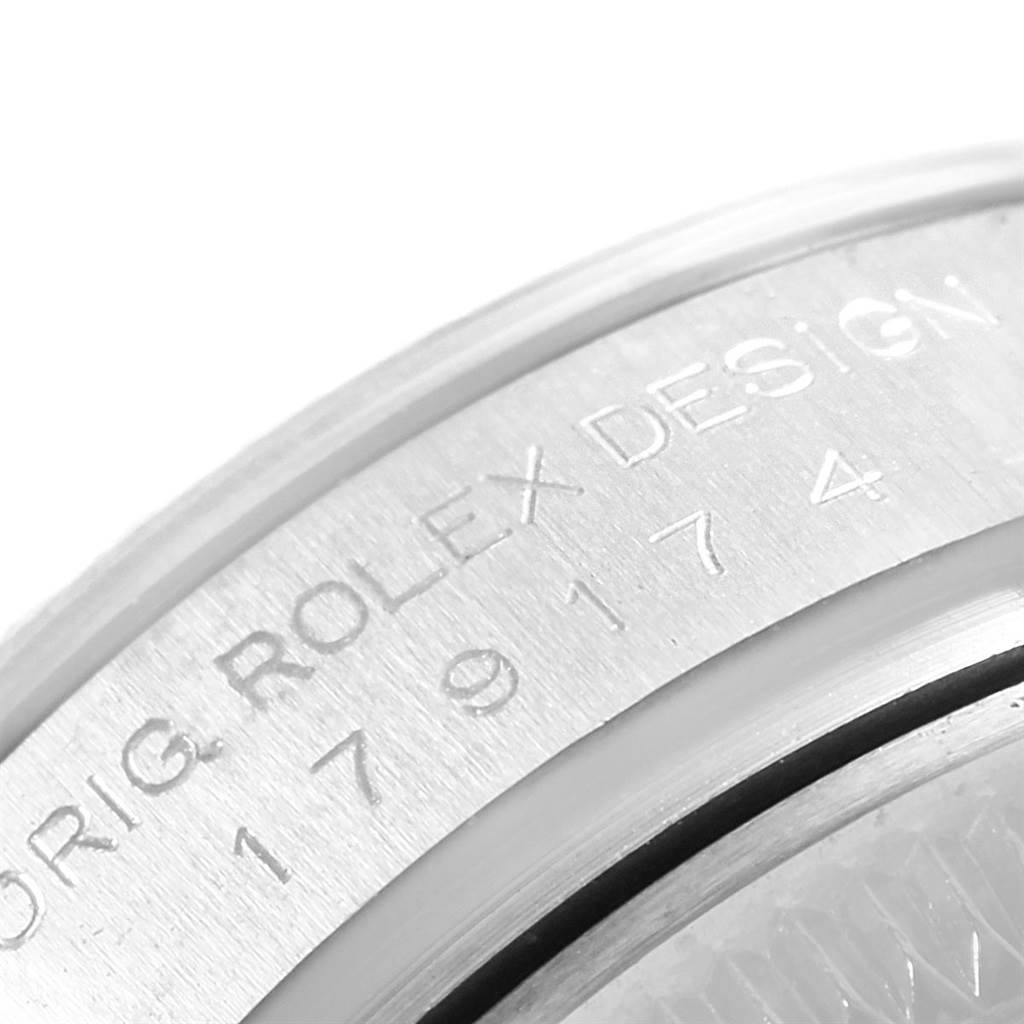 This close-up image shows the engraved text on the case back of a Rolex Datejust 179174 Women's Stainless Steel Mother of Pearl Dial 179174 Women's Stainless Steel Mother of Pearl Dial watch.