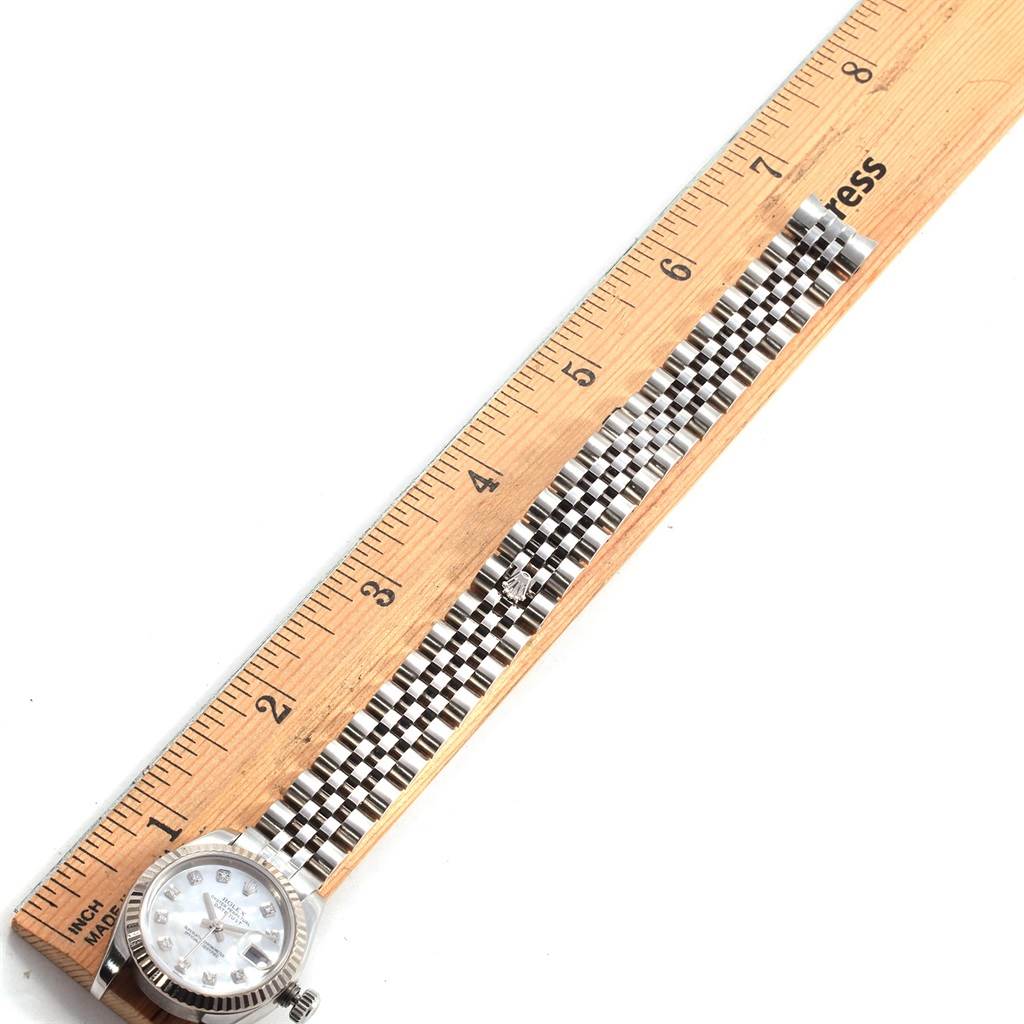 The image shows a Rolex Datejust 179174 Women's Stainless Steel Mother of Pearl Dial 179174 Women's Stainless Steel Mother of Pearl Dial watch laid along a ruler, emphasizing the face and full bracelet length.
