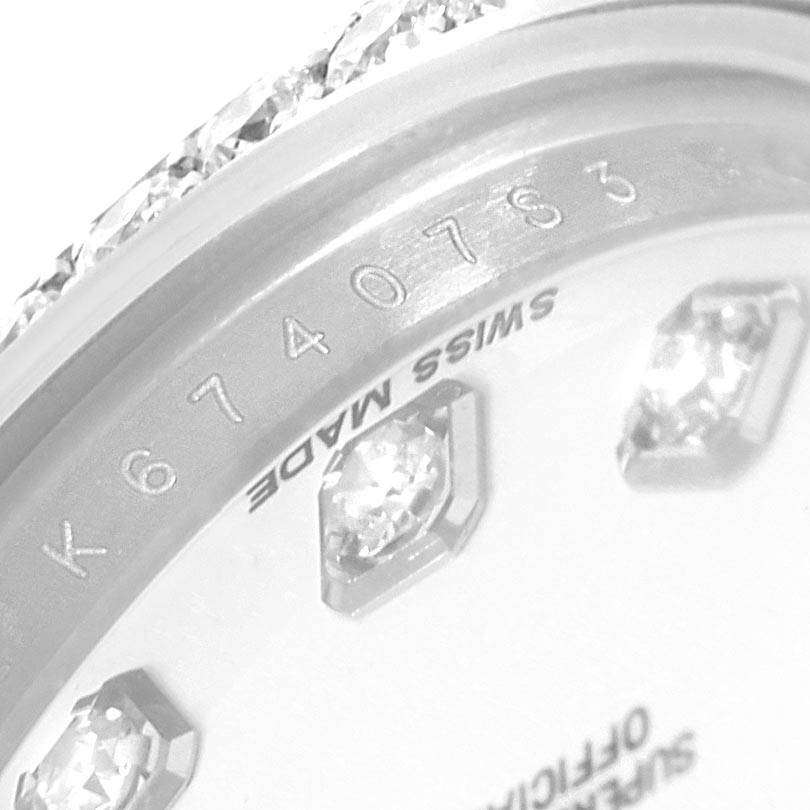 This close-up image of a Rolex Datejust 179384 Women's Stainless Steel White Dial 179384 Women's Stainless Steel White Dial watch shows part of the dial, diamonds, and the "Swiss Made" marking.
