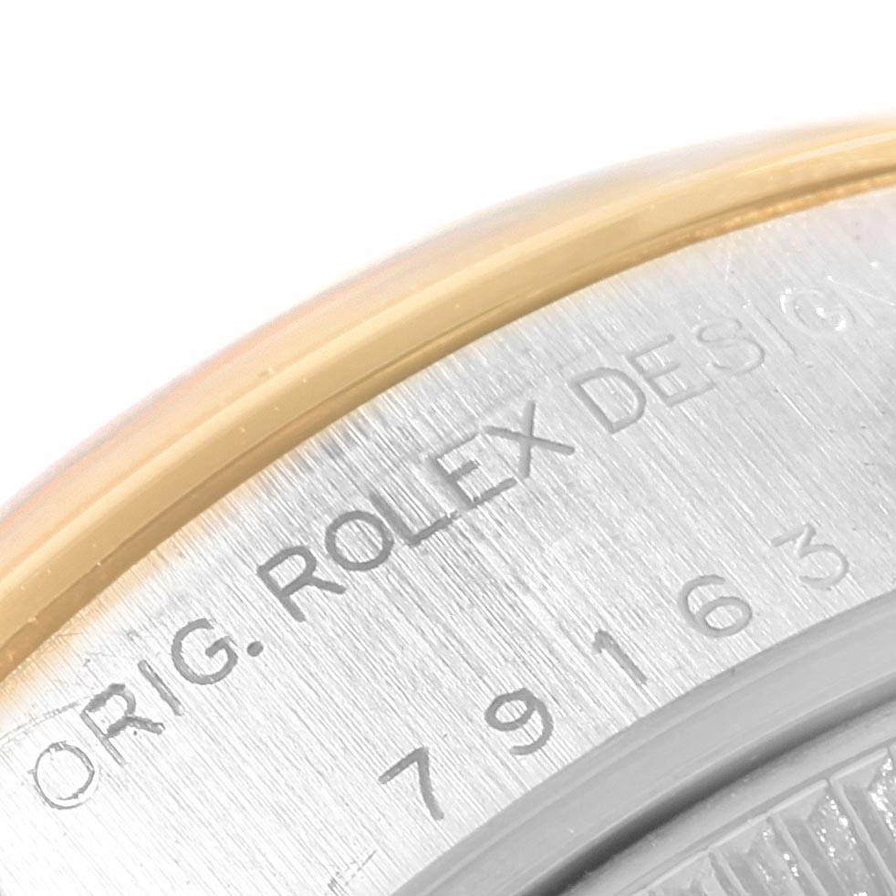 This close-up image shows the engraved backside of a Rolex Datejust 79163 Women's Steel and Gold (two tone) Silver Dial 79163 Women's Steel and Gold (two tone) Silver Dial watch, including part of its serial number and "ORIG. ROLEX DESIGN" text.