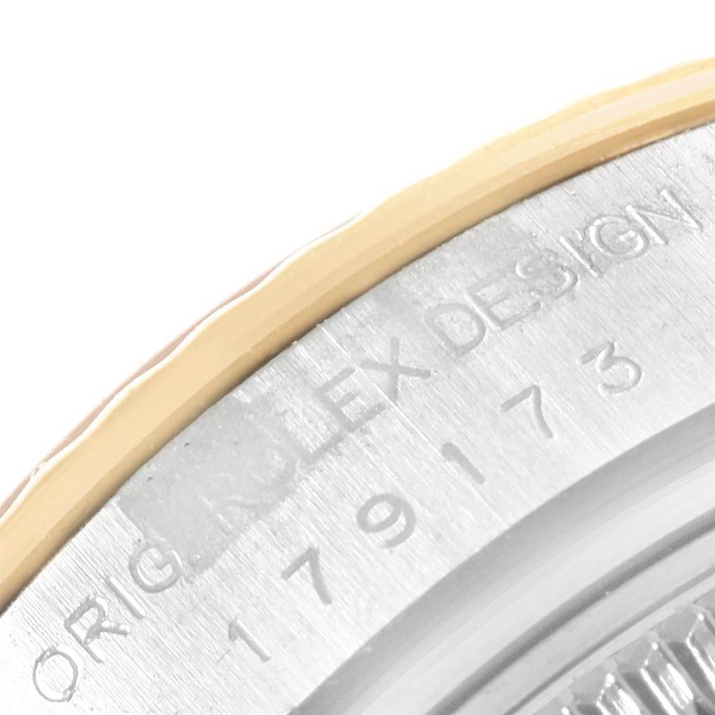 The image shows a close-up of the case back edge, engraving, and part of the bezel of the Rolex Datejust 179173 Women's Steel and Gold (two tone) Beige Dial 179173 Women's Steel and Gold (two tone) Beige Dial model.