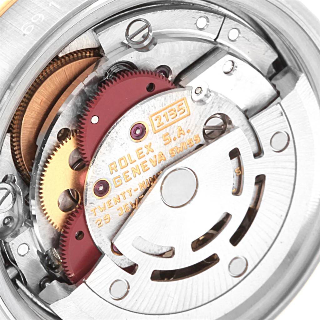 This image shows a close-up of the movement mechanism inside a Rolex Datejust 69173 Women's Stainless Steel Champagne Dial 69173 Women's Stainless Steel Champagne Dial watch, featuring the gears and internal components.