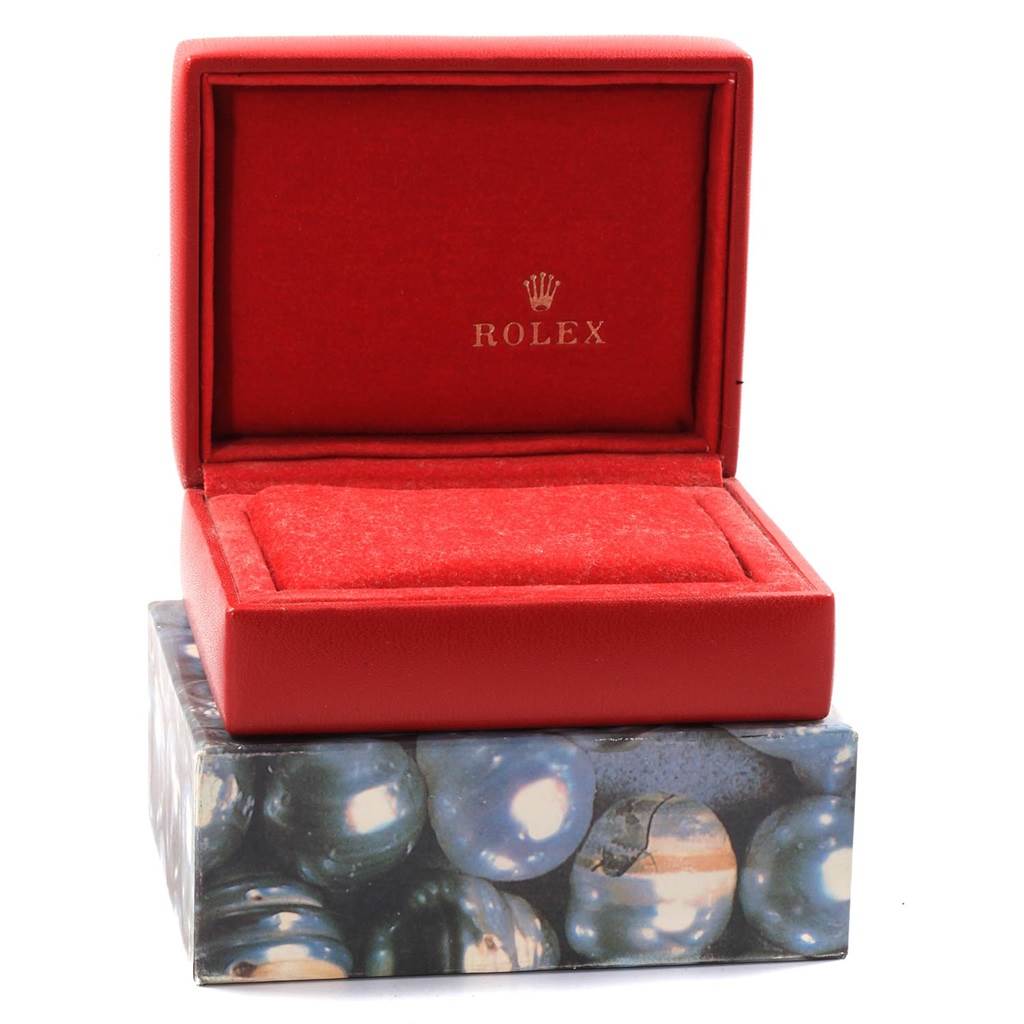 The image shows an open red Rolex watch box for the Datejust model, revealing its interior and outer decorative box.