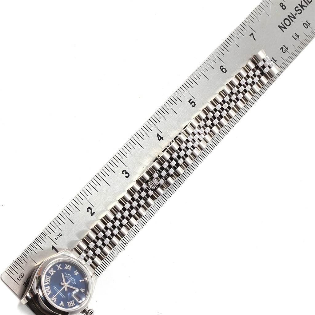 The image shows a Rolex Datejust 179160 Women's Stainless Steel Blue Dial 179160 Women's Stainless Steel Blue Dial watch laid flat, with the face partially visible, and a ruler measuring the length of the bracelet.