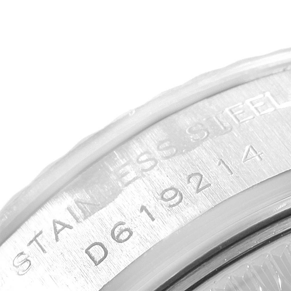 The image shows a close-up of the serial number engraving on the stainless steel case back of a Rolex Datejust 179174 Women
s Stainless Steel Black Dial 179174 Women
s Stainless Steel Black Dial watch.