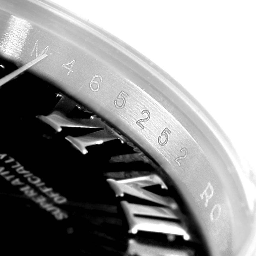 This is a close-up of the serial number engraved on the bezel of a Rolex Datejust 179174 Women's Stainless Steel Black Dial 179174 Women's Stainless Steel Black Dial watch.