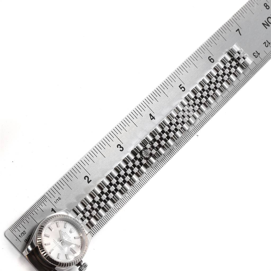 This image shows a full view of the Rolex Datejust 179174 Women's Stainless Steel Silver Dial 179174 Women's Stainless Steel Silver Dial watch next to a ruler, highlighting the watch case and bracelet.