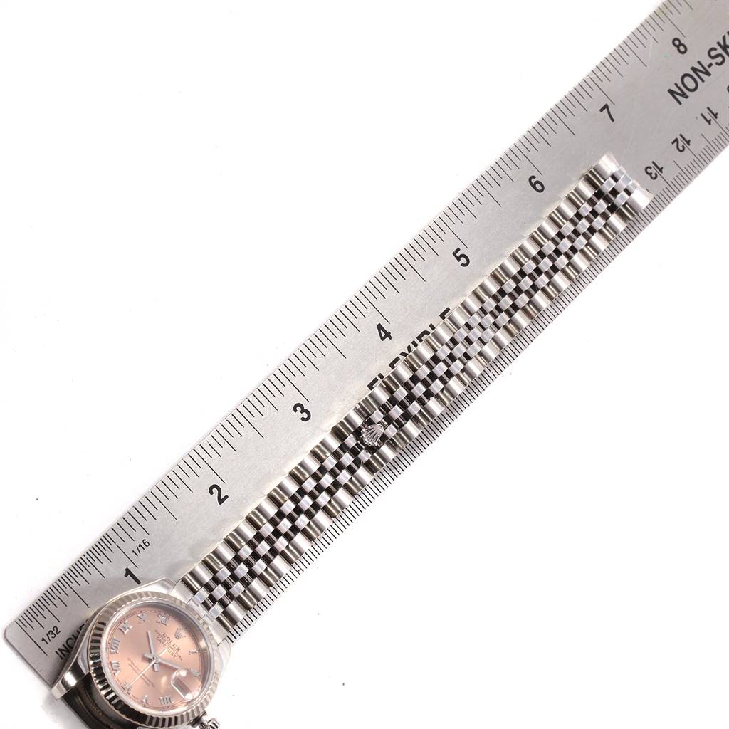 The image shows the face and partial band of a Rolex Datejust 179174 Women's Stainless Steel Pink Dial 179174 Women's Stainless Steel Pink Dial watch next to a ruler for scale.