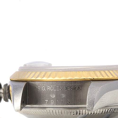 The image shows a side view of the case and bezel of a Rolex Datejust 79173 Women's Stainless Steel Beige Dial 79173 Women's Stainless Steel Beige Dial, displaying part of the crown and engraved text.