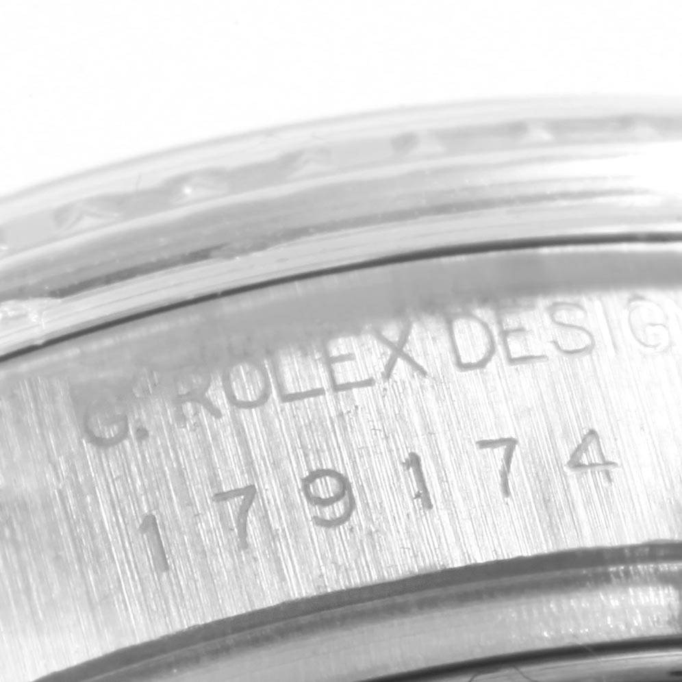 The image shows a close-up of the inner bezel of a Rolex Datejust 179174 Women's Stainless Steel Mother of Pearl Dial 179174 Women's Stainless Steel Mother of Pearl Dial model, revealing engraved text and numbers.