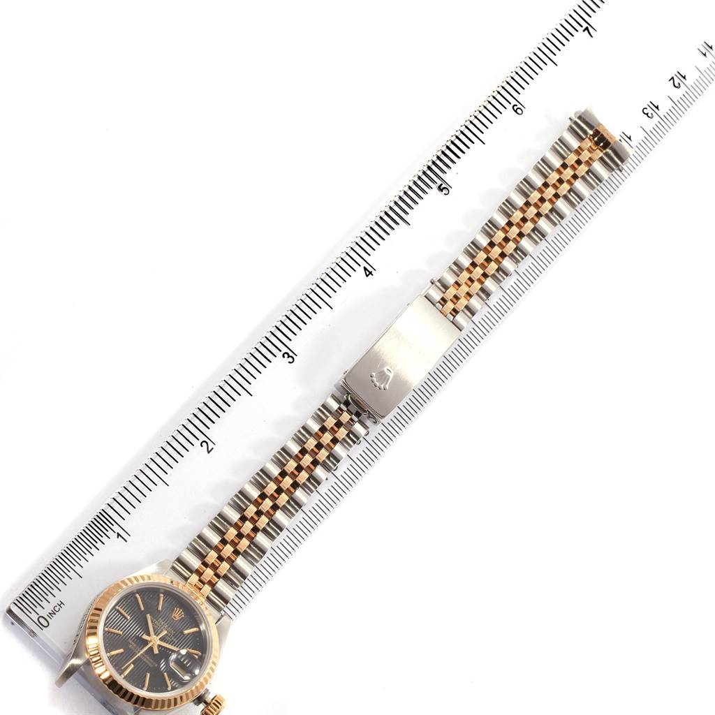 The image shows a Rolex Datejust 69173 Women's Stainless Steel Black Dial 69173 Women's Stainless Steel Black Dial watch laid flat, displaying the face, case, and metal bracelet alongside a ruler for scale.