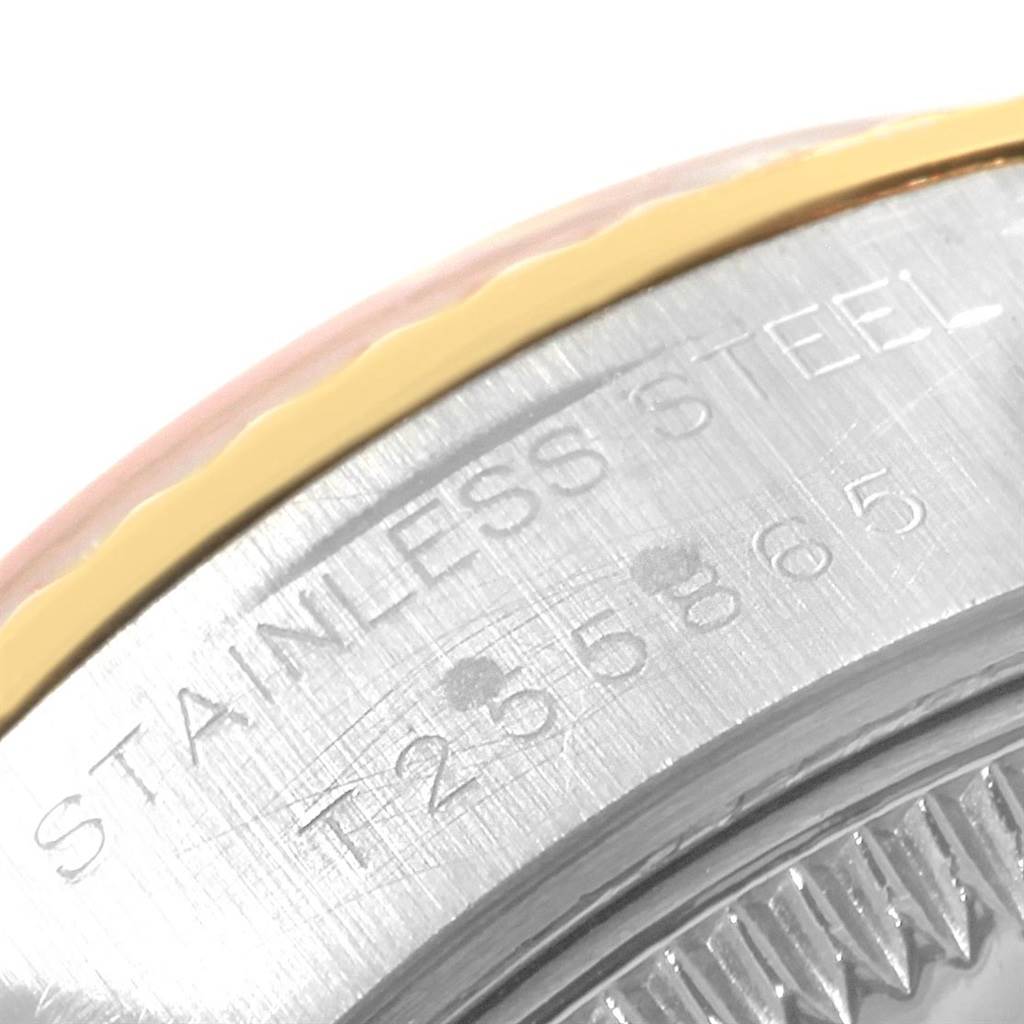 Close-up of a partial view of the back and bezel of a Rolex Datejust 69173 Women's Stainless Steel Black Dial 69173 Women's Stainless Steel Black Dial watch, showing "STAINLESS STEEL" engraving.