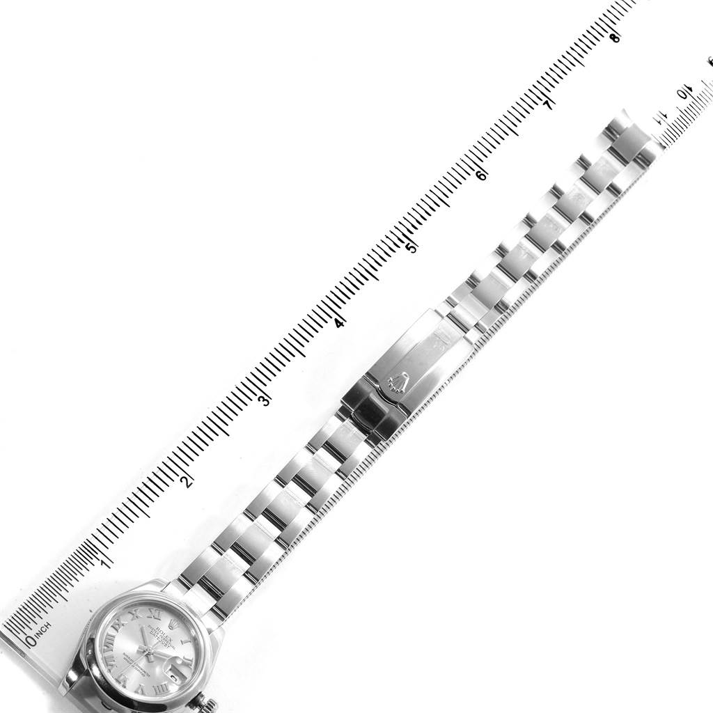 The image shows a Rolex Datejust 179160 Women's Stainless Steel Silver Dial 179160 Women's Stainless Steel Silver Dial watch laid flat alongside a ruler, displaying the watch face, bracelet, and clasp.