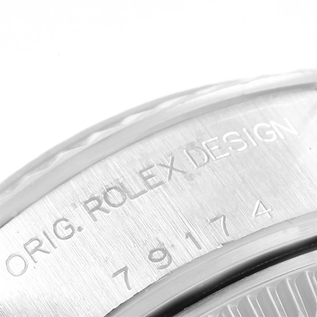 The image shows a close-up of the caseback edge of a Rolex Datejust 79174 Women's Stainless Steel Black Dial 79174 Women's Stainless Steel Black Dial, highlighting the engraved model number and "ORIG. ROLEX DESIGN" inscription.
