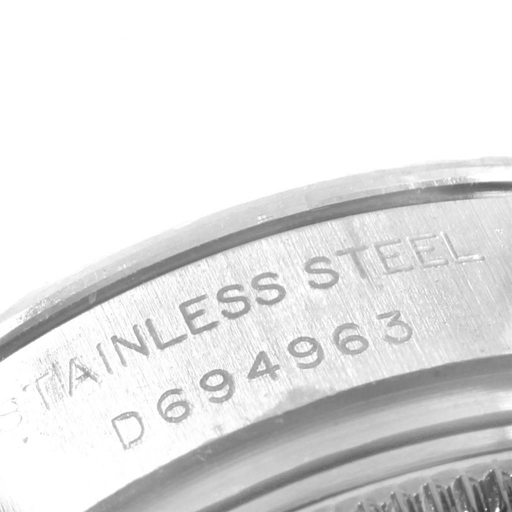 The image shows a close-up of the serial number and "STAINLESS STEEL" engraving on the case back of a Rolex Datejust 179174 Women's Stainless Steel Black Dial 179174 Women's Stainless Steel Black Dial watch.
