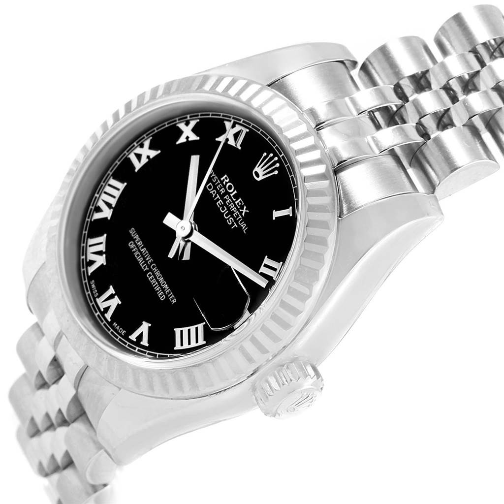 The image shows a Rolex Datejust 179174 Women's Stainless Steel Black Dial 179174 Women's Stainless Steel Black Dial watch at an angled close-up, highlighting its black dial, Roman numerals, fluted bezel, and Jubilee bracelet.