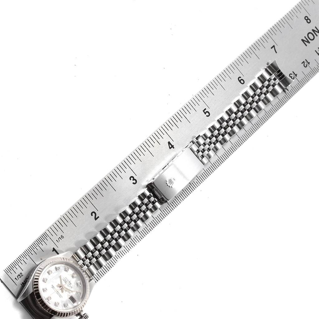 The image shows a Rolex Datejust 79174 Women's Stainless Steel Mother of Pearl Dial 79174 Women's Stainless Steel Mother of Pearl Dial watch with a jubilee bracelet measured against a ruler.