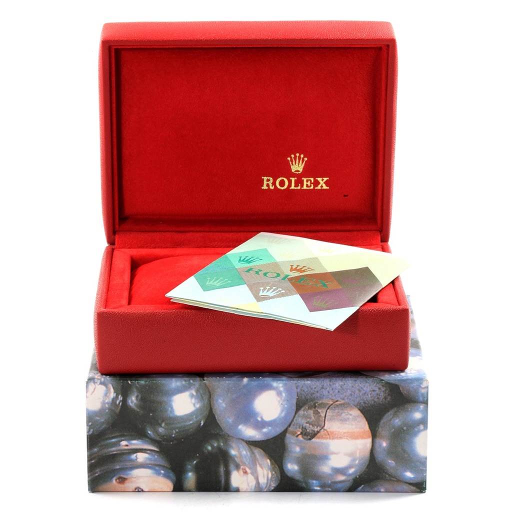 The image shows an open red Rolex box with a booklet on top, meant for a Datejust model.