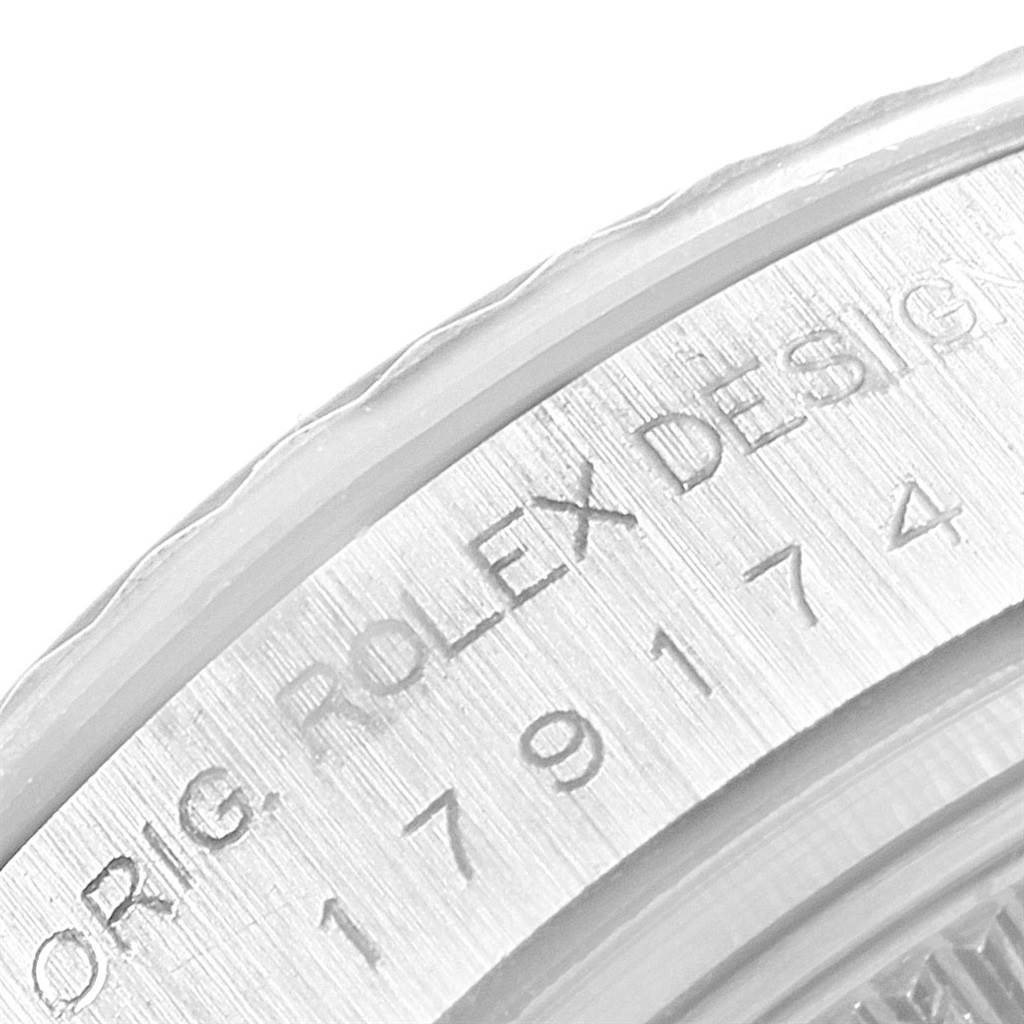 This close-up image shows the engraved bezel with the serial number of a Rolex Datejust 179174 Women
s Stainless Steel White Dial 179174 Women
s Stainless Steel White Dial watch.