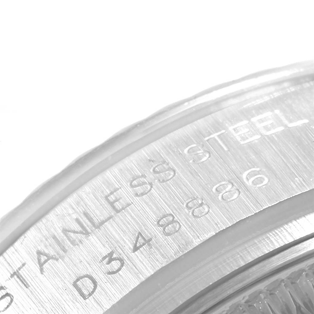 This close-up image shows the side of a Rolex Datejust 179174 Women
s Stainless Steel White Dial 179174 Women
s Stainless Steel White Dial model, highlighting the engraved "STAINLESS STEEL" text and serial number.