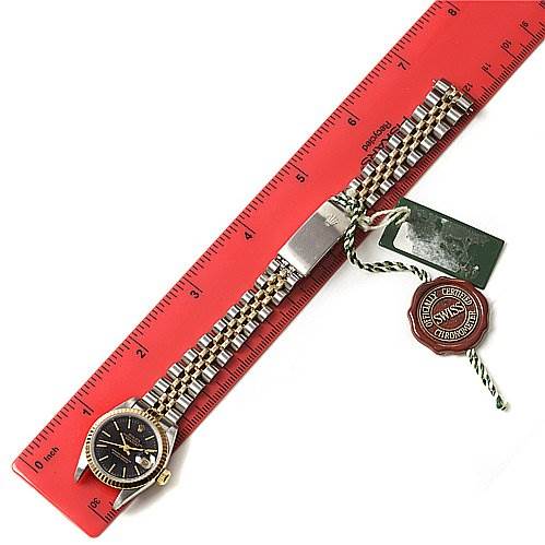 The image shows a Rolex Datejust 69173 Women's Stainless Steel Black Dial 69173 Women's Stainless Steel Black Dial watch lying flat with a ruler for scale, displaying the face, bracelet, tags, and clasp.