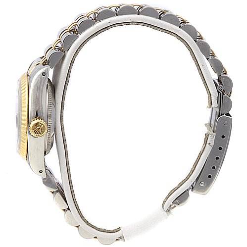 The image shows a side view of a Rolex Datejust 69173 Women's Stainless Steel Blue Dial 69173 Women's Stainless Steel Blue Dial watch, highlighting the gold crown, bezel, and metal bracelet.