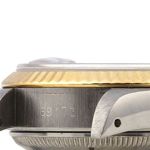 This image shows a side angle of a Rolex Datejust 69173 Women's Stainless Steel Blue Dial 69173 Women's Stainless Steel Blue Dial watch emphasizing the bezel, case, and engraved serial number.