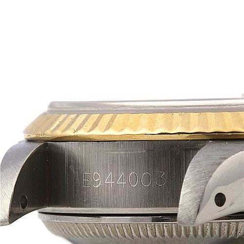 This image shows a close-up side view of the Rolex Datejust 69173 Women's Stainless Steel Blue Dial 69173 Women's Stainless Steel Blue Dial watch's bezel, case, and part of the lug, with serial number visible.