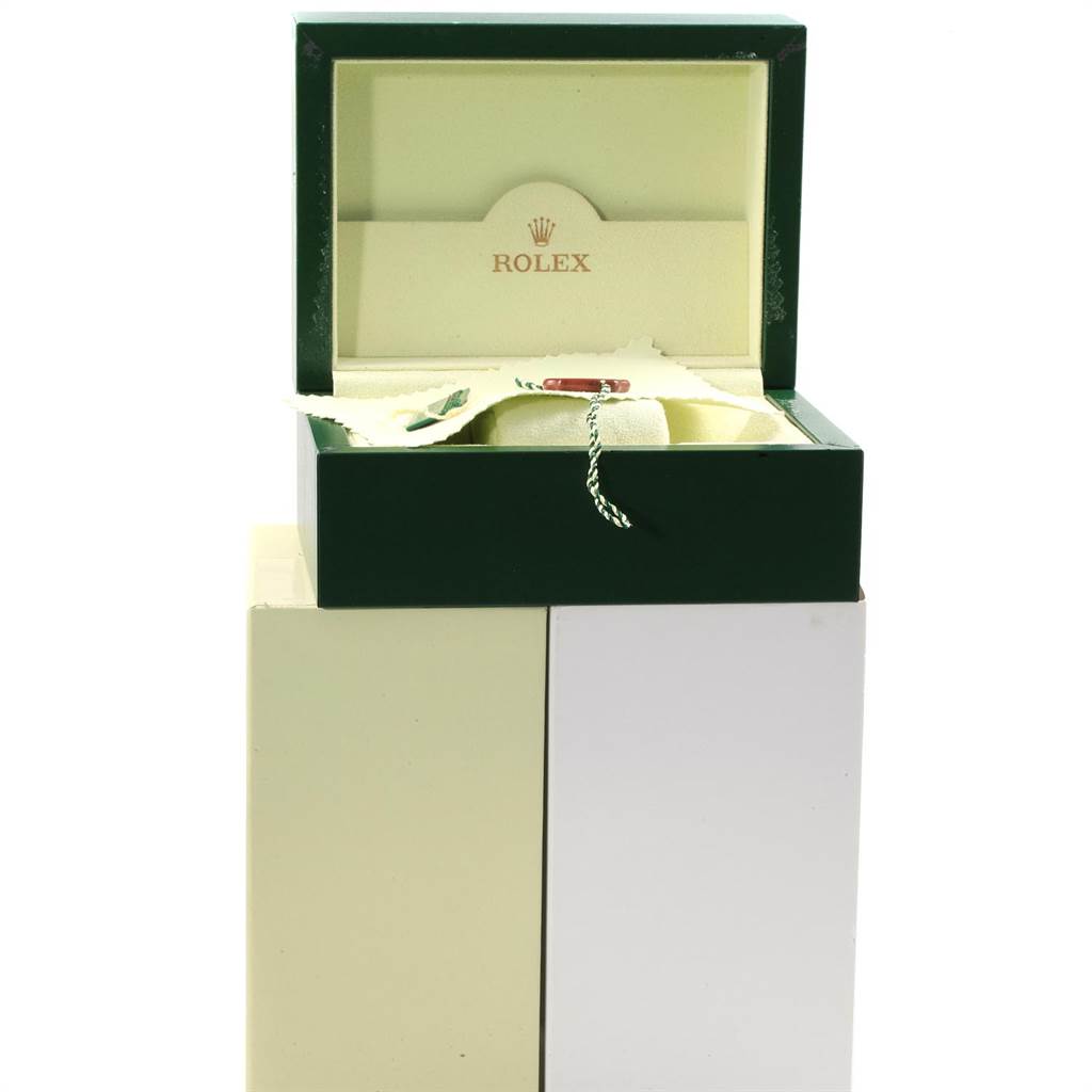 This image shows an open green Rolex box for the Datejust model, displaying part of its interior and a tag.