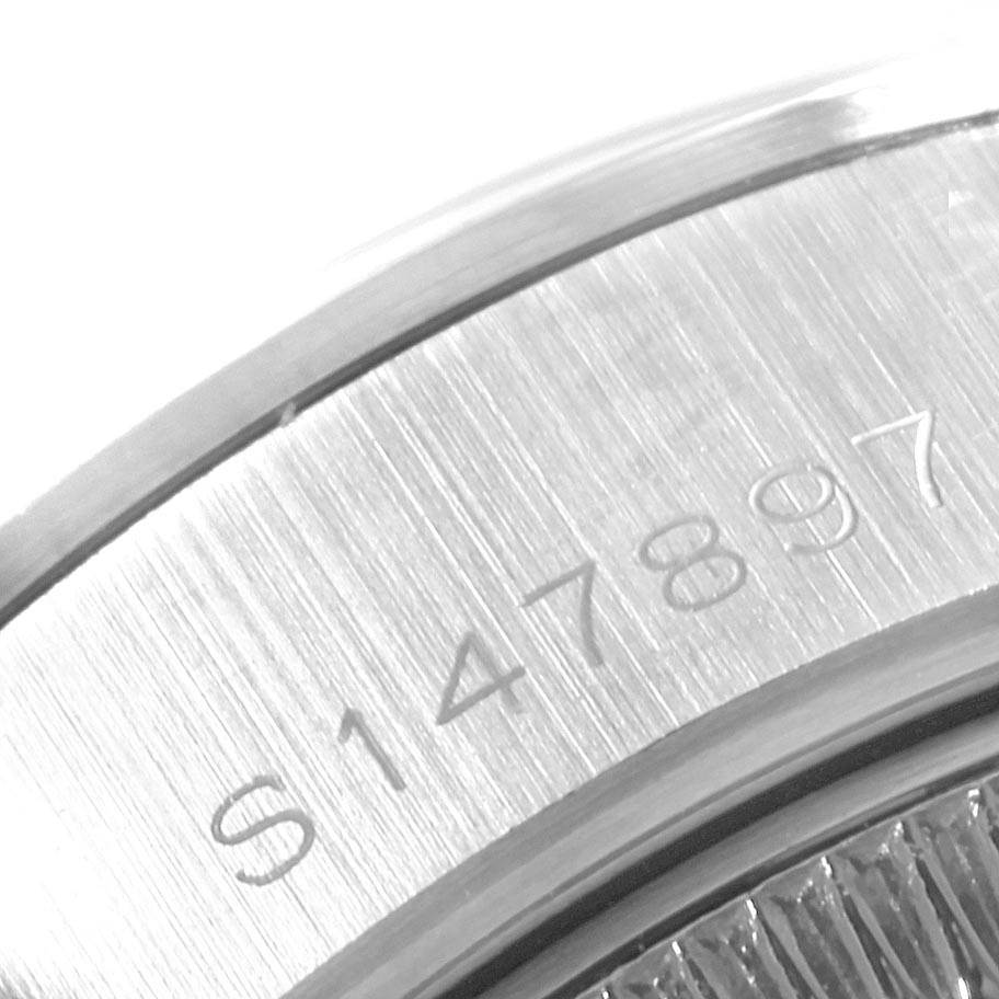 This close-up image shows the serial number engraved on the side of a Rolex Datejust 69160 Women's Stainless Steel Black Dial 69160 Women's Stainless Steel Black Dial watch case.