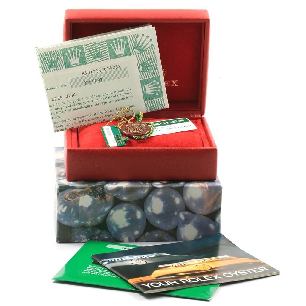 The image shows a red box containing accessories and documents for the Rolex Datejust 69173 Women
s Stainless Steel Champagne Dial 69173 Women
s Stainless Steel Champagne Dial watch.