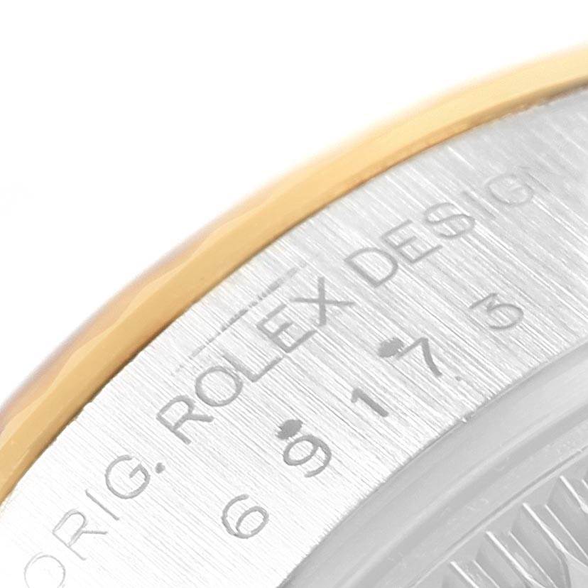 This is a close-up view of the casing edge and serial engraving of a Rolex Datejust 69173 Women's Stainless Steel Champagne Dial 69173 Women's Stainless Steel Champagne Dial watch.