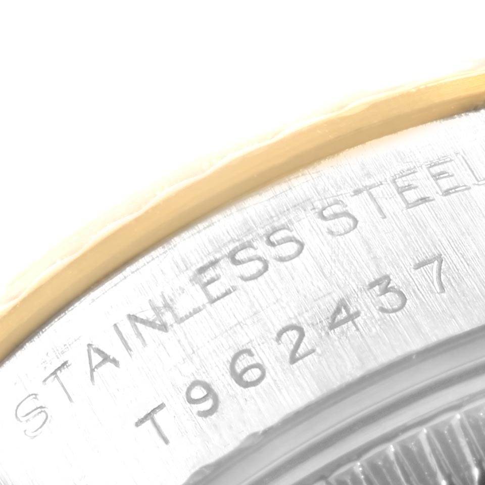 This close-up angle shows part of the stainless steel case back of a Rolex Datejust 69173 Women's Stainless Steel Champagne Dial 69173 Women's Stainless Steel Champagne Dial watch with the engraved model and serial numbers.