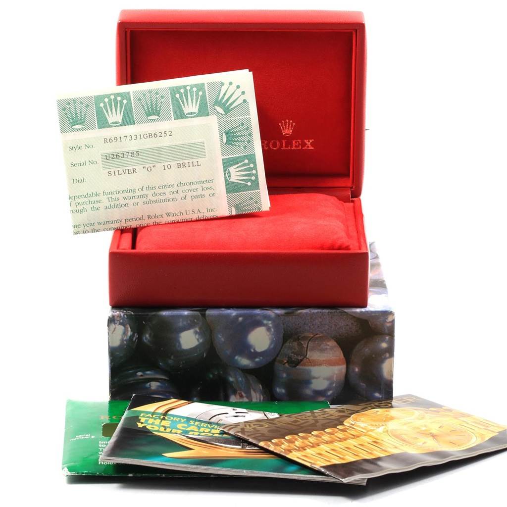 This image shows the open box and documents for a Rolex Datejust 69173 Women's Stainless Steel Silver Dial 69173 Women's Stainless Steel Silver Dial watch.