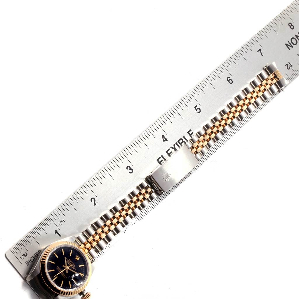 The image shows a top-down view of a Rolex Datejust 69173 Women's Stainless Steel Black Dial 69173 Women's Stainless Steel Black Dial watch laid alongside a ruler, showcasing the band and part of the watch face.