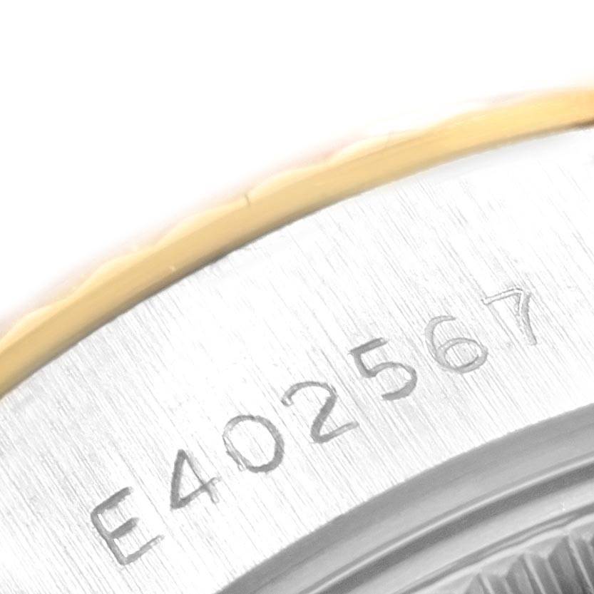 This image shows a close-up of the serial number engraving on a Rolex Datejust 69173 Women's Stainless Steel Black Dial 69173 Women's Stainless Steel Black Dial watch bezel.