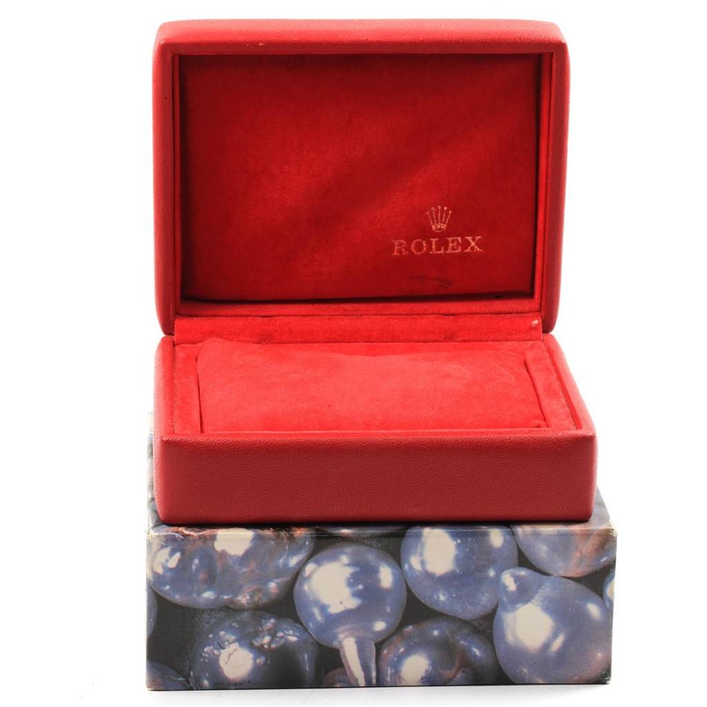 This image shows an open red Rolex watch box, displaying the interior cushion and the logo, associated with the Datejust model.